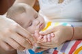 mother cuts little baby's nails. Selective focus.