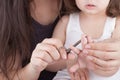 Mother cutting kids nails Royalty Free Stock Photo