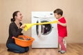 Mother and daugher playing near the washing machine Royalty Free Stock Photo