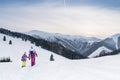 Mother with daugher walking hand in hand by snow moontain trail. Active outdoor time spending concept image Royalty Free Stock Photo