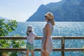 Mother and daughter admire the scenery of the Alps and Lake Garda at Italy Royalty Free Stock Photo