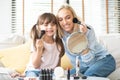 Mother and daughter applying cosmetic Royalty Free Stock Photo