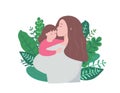 Mother and daughter on a background of leaves. A young woman holds a child in her arms and kisses it.