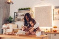 Mother and daughter baking Christmas biscuits on kitchen at home. Little girl whisking eggs helping mom with cooking Royalty Free Stock Photo