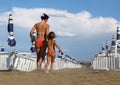 Mother and daughter in bathing suit going on beach Royalty Free Stock Photo
