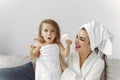 Mother with daughter in bathrobe and towels Royalty Free Stock Photo