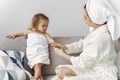 Mother with daughter in bathrobe and towels Royalty Free Stock Photo