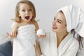 Mother with daughter in bathrobe and towels Royalty Free Stock Photo