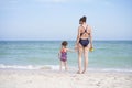 Mother daughter beach together rear view Unrecognizable caucasian woman little girl swimwear standing seaside back Royalty Free Stock Photo