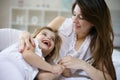 Mother and daughter in the bed together.