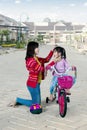 Mother and daughter with a bicycle outdoors Royalty Free Stock Photo