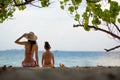 Mother and daughter in bikini sit on beach Royalty Free Stock Photo