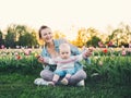 Mother and daughter among blooming tulips flowers Royalty Free Stock Photo