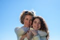 Mother and daughter with the blue sky in the background