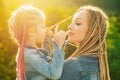 Mother and daughter with braiding hair. Nice child girl with plaits. Hair in trendy weave plait.