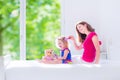 Mother and daughter brushing hair