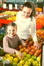 Mother and daughter buying apples Royalty Free Stock Photo