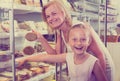 Mother with daughter buying chilled foods in supermarket Royalty Free Stock Photo