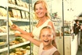 Mother with daughter buying chilled foods in supermarket Royalty Free Stock Photo