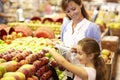 Mother and daughter buying fruit in supermarket Royalty Free Stock Photo