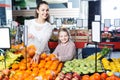 Mother and daughter buying ripe fruits Royalty Free Stock Photo