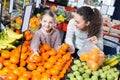 Mother and daughter buying ripe fruits together Royalty Free Stock Photo