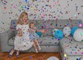 Mother and daughter celebrate birthday with ballons and confetti.