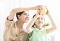 Mother and daughter checking the piggy bank for her future savings Royalty Free Stock Photo