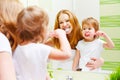 Mother and daughter child girl brushing her teeth toothbrushes f Royalty Free Stock Photo