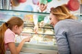 Mother and daughter chooses ice cream in confectionery Royalty Free Stock Photo