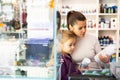 Mother with daughter choosing aquarium accessories in pet shop Royalty Free Stock Photo