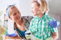 Mother and daughter cleaning their house