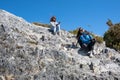 Mother and daughter climb and rest on cliff