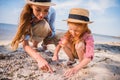 Mother and daughter collecting seashells Royalty Free Stock Photo