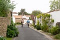 Mother and daughter come back from the market of the Ile de RÃÂ© by bike in the alley in France