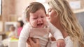 Mother and daughter consueling baby crying at kindergarten Royalty Free Stock Photo