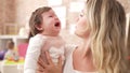 Mother and daughter consueling baby crying at kindergarten Royalty Free Stock Photo