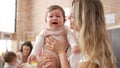 Mother and daughter consueling baby crying at kindergarten Royalty Free Stock Photo