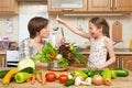 Mother and daughter cook and taste soup from vegetables. Home kitchen interior. Parent and child, woman and girl. Healthy food con Royalty Free Stock Photo