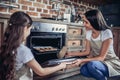 Mother and daughter cooking cookies