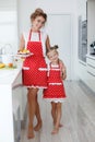 Mother and daughter cooking cupcakes on the festive table Royalty Free Stock Photo