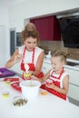 Mother and daughter cooking cupcakes on the festive table Royalty Free Stock Photo