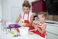 Mother and daughter cooking cupcakes on the festive table Royalty Free Stock Photo