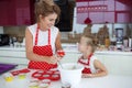 Mother and daughter cooking cupcakes on the festive table Royalty Free Stock Photo