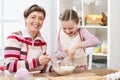 Mother and daughter cooking and having fun, home kitchen interior, healthy food concept Royalty Free Stock Photo