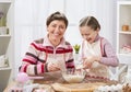 Mother and daughter cooking and having fun, home kitchen interior, healthy food concept Royalty Free Stock Photo