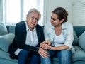 Mother and daughter crying at home in quarantine grieving loss of family members amid COVID-19 Royalty Free Stock Photo