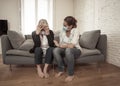 Mother and daughter crying at home in quarantine grieving loss of family members amid COVID-19 Royalty Free Stock Photo