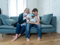 Mother and daughter crying at home in quarantine grieving loss of family members amid COVID-19 Royalty Free Stock Photo