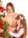 Mother with daughter decorate Christmas tree.